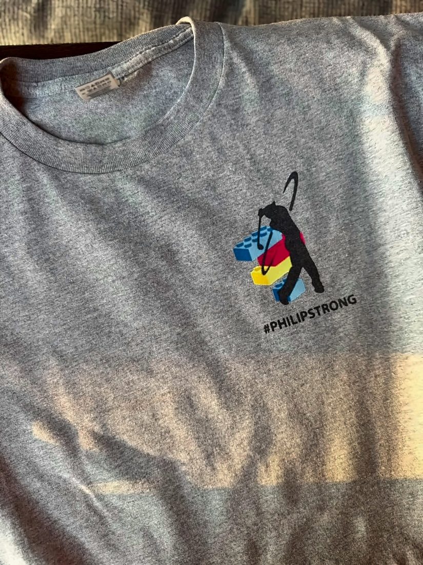 Grey t-shirt printed with a colorful PhilipStrong design